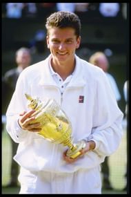 Richard Krajicek of the Netherlands holds the mens singles trophy after defeating Malivai Washington of the USA in straight sets in the mens final of the Wimbledon tennis championships at the all England Club in London, England in 1996. (Getty Images)